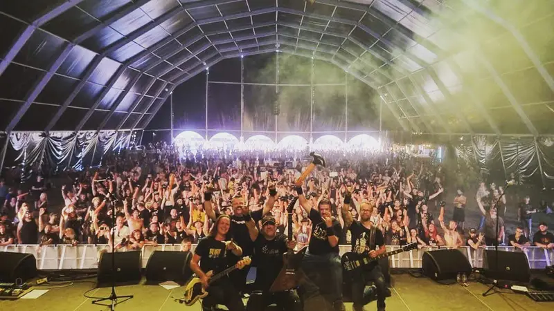 Crowd and merch crew in a festival tent