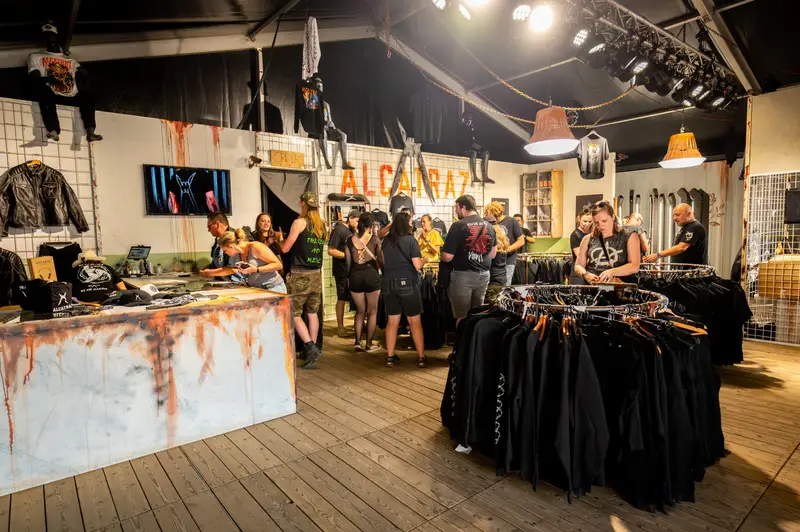 Fans browsing merch racks in a festival shop