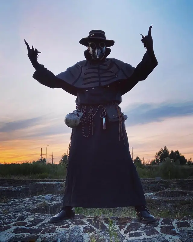 Plague doctor performer at sunset